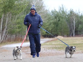 Blair Holub takes Pepper, left, and Sophia for a walk on the trails at Fielding Memorial Park in Greater Sudbury, Ont. on Tuesday November 17, 2020.