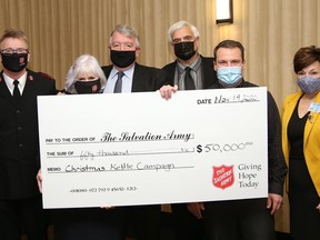 Brothers Gerry Jr. and Geoffrey Lougheed, of the Lougheed Foundation, made a $50,000 donation to the Sudbury Salvation Army Christmas Kettle Campaign at the Rotary Club of Sudbury Sunrisers breakfast meeting in Sudbury, Ont. on Thursday November 19, 2020. The cheque presentation included Capt. Jim VanderHeyden, left, and Capt. Deb VanderHeyden, of the Salvation Army, the Lougheed brothers, and Rotary Club of Sudbury Sunrisers Trevor Gilchrist, kettle campaign chair, and Luann Belfry, president. The Christmas Kettle Campaign kicks off in Greater Sudbury on Nov. 20 and runs until Dec. 24.