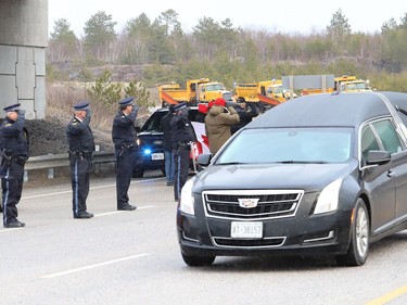 Local Ontario Provincial Police officers gathered at the overpass near Estaire to show their respect for a procession featuring OPP Const. Marc Hovingh's body on Monday November 23, 2020. John Lappa/Sudbury Star/Postmedia Network