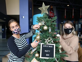 Business owners Valerie Fremlin, left, and Kelsey Cutinello, of La Fromagerie, decorate a tree they donated to the Festival of Trees fundraiser at Science North in Sudbury, Ont. on Tuesday November 24, 2020. "This year the festival has been renewed in the style of a virtual silent auction taking place from November 27 through to December 6," said a release issued by Science North. "This year's event features over 15 trees donated by local businesses and organizations with the goal of raising $20,000 to support initiatives at Science North and other groups supported by the Sudbury Charities Foundation." The trees will be unveiled to the media and community members on Nov. 26. For more information on the fundraiser, or to make a bid, go to 32auctions.com/sudburyfestivaloftrees.