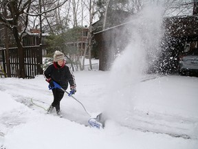 Rena Alikhan uses her electric snow shovel to clear her driveway in Sudbury, Ont. on Wednesday November 25, 2020.