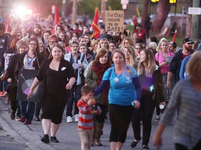 Participants march during the annual Centre Victoria pour femmes and  Voices for Women Sudbury Sexual Assault Centre's Take Back The Night in Sudbury, Ont. on Thursday September 29, 2016.