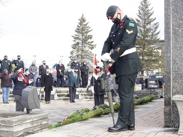A member of the firing party from the Algonquin Regiment, right, bows his head during the Remembrance Day ceremony held at the Timmins Cenotaph Wednesday.

RICHA BHOSALE/The Daily Press