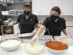 Gail Bouchard, kitchen prep at the Porcupine Dante Club, left, and the club's sous-chef Melanie Quakegesic, were preparing lasagna which is one of the specialties the club is serving up for its annual fundraiser.

RICHA BHOSALE/The Daily Press