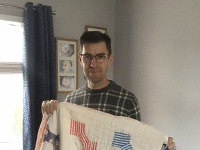 Gary Beardsley with the Red Cross quilt from Owen Sound that his family was given after their London-area home was bombed during the Second World War.