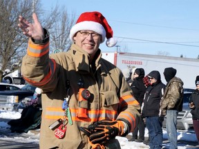 Tillsonburg firefighter Ted Sanders greets parade viewers during last year's Tillsonburg and Area Optimist Club Santa Claus Parade. This year, unable to hold a parade, the Optimist Club is planning a Christmas Display on Nov. 21 - and the firefighters have been invited to attend the event. (Chris Abbott/Norfolk and Tillsonburg News)