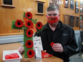 Jason Lava, the first vice-president with the Royal Canadian Legion Branch 12 Kenora, shows off some of the poppies, pins and masks available for sale at the Legion's clubhouse on Matheson Street.