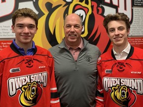 Owen Sound Attack players Deni Goure (left) and Ethan Burroughs (right) - pictured with Attack GM Dale DeGray following the 2019 OHL Draft - have made the NHL Central Scouting Bureau's players to watch list ahead of the 2021 NHL Entry Draft. Photo supplied.