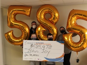 John Joy of Lively and his family pick up the $585,478 he won playing the Health Sciences North 50/50 Cash Lottery for the North. Supplied