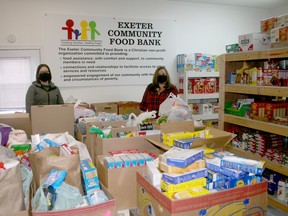 Exeter Community Food Bank treasurer Maggie McBride, left, and manager Laurie Clapp, right, are thanking the community for its support of the food bank during the pandemic. A community-wide food drive in November had an overwhelming response, and countless businesses, groups and individuals have donated to the food bank.