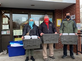 Syrian refugees and Sarnia residents Naser and Nour Othman drop off 40 home-cooked meals to the Inn of the Good Shepherd on Dec. 18. From left to right: Nour Othman, the Inn of the Good Shepherd’s Myles Vanni and Naser Othman. Handout/Sarnia This Week