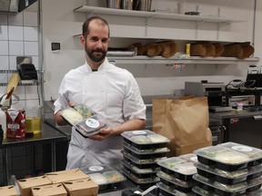 Alex Lussier, of West Coast Food Catering, puts the finishing touches on his home-cooked meals, 41 of which were donated to members of the community on Wednesday, December 30. SUBMITTED