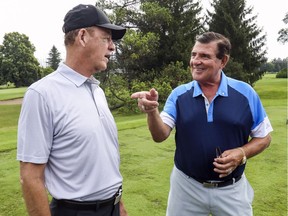Former Montreal Canadiens Bobby Smith, left, and Serge Savard have a conversation at Savard's annual golf tournament at Islesmere Golf Club in Laval on Aug. 19, 2019. Savard was Canadiens general manager when Smith played for the team.