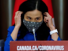 FILE PHOTO: Canada's Chief Public Health Officer Dr. Theresa Tam puts on a mask at a news conference held to discuss the country's coronavirus disease (COVID-19) response in Ottawa, Ontario, Canada. November 6, 2020. REUTERS/Patrick Doyle/File Photo