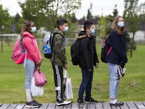 Sturgeon Public School teachers are gearing up for a strike over stalled contract talks. Pictured, teachers greet students at Archbishop Joseph MacNeil Catholic School on the first day of school, amid the COVID-19 pandemic on Wednesday, Sept. 2, 2020. PHOTO BY GREG SOUTHMAN / Postmedia, file.