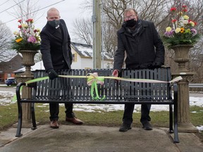 Jeremy Gofton, executive director of Victim Services of Oxford County, on the left, and Tillsonburg Mayor Stephen Molnar dedicate a new memorial bench at Lake Lisgar in Tillsonburg recognizing victims and survivors of crime. (Chris Abbott/Postmedia News)