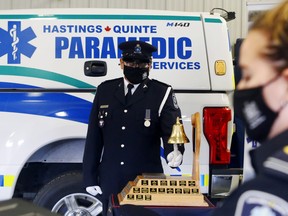 Advanced care paramedic Dave Valdes rings the Paramedic Memorial Bell Tuesday at Hastings-Quinte Paramedic Services headquarters in Belleville, Ont. At right, advanced care paramedic Danielle Spitzig reads the names of 51 Canadian paramedics who have died in the line of duty. Luke Hendry/The  Intelligencer/Postmedia Network
FOR PAGINATORS:
Advanced care paramedic Dave Valdes rings the Paramedic Memorial Bell as advanced care paramedic Danielle Spitzig reads the names of 51 Canadian paramedics who have died in the line of duty.