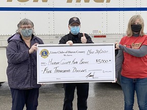All the Lions Clubs in Huron County recently banded together to donate $5,000 to the Huron County Food Bank Distribution Centre. Auburn and District Lions president Travis Teed, centre, said typically the individual Lions clubs make separate donations but this year they decided to put their money together for one large donation. Pictured at the cheque presentation recently in Wingham are Huron County Food Bank Distribution Centre executive director Mary Ellen Zielman, left, and Roxanne Nicholson of North Huron Food Share in Wingham, right. Teed also gave credit to Centralia’s Premium Transportation, where the distribution centre is housed, for its generosity to the organization. Handout