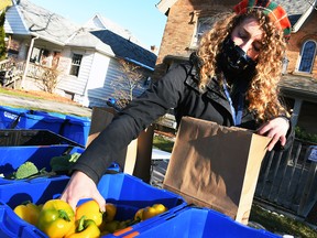 Heather Tulloch, community food connector with the Chatham-Kent Prosperity Roundtable, loads up a bag of fresh produce at the Mobile Market stop at Hope House in Chatham Dec. 3, 2020. (Tom Morrison/Chatham This Week)