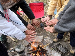 This group of homeless people are seen around a fire in a file photo taken in November 2019. A community-led effort is being made to help provide permanent housing, with supports to address this issue of homeless in Chatham-Kent. Ellwood Shreve/Postmedia Network