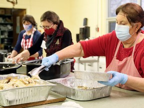 Grace Magliaro, right, Jane Butterman and Jan Brosseau package meals during Interfaith Caring Kitchen’s annual Christmas dinner Wednesday at the Spirit & Life Centre in Chatham. Approximately 250 takeout meals were prepared for the hungry. Meals included turkey, mashed potatoes, stuffing, vegetables, gravy, cranberry sauce, pickles, buns and cupcakes. The dinner was changed this year to takeout from a sit-down affair because of the COVID-19 pandemic. The Interfaith Caring Kitchen – run by local Muslims and Christians, with financial help from TekSavvy – also serves takeout meals at St. Ursula Parish on the first and third Wednesdays of each month. Mark Malone