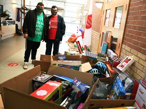 Chatham brothers Derek and Brett Gore pose for a photo with the haul of toys they donated to the Salvation Army Chatham-Kent Ministries at the Orangewood Boulevard site on Dec. 3, 2020. They purchased the toys using $5,214 they received by collecting and turning in used bottles and cans. (Tom Morrison/Chatham This Week)