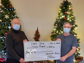 Ron Friend and Kerry Law present a $500 cheque to be donated to the Fort Saskatchewan Food Bank on behalf of the Southfort Bend Gardens Social Committee. Photo Supplied by Tammy Franklin.