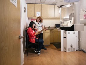 A nurse speaks with a patient inside a mammogram screen test trailer. Photo Supplied by Alberta Health Services / file.