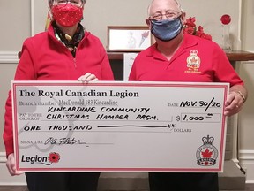 Heather Finnie, co-ordinator of the Kincardine Christmas Hamper program, receives a cheque for $1,000 from Bob Fletcher, president of the Kincardine Legion. Finnie says that there was a significant increase in demand tis year, and the community generously met that need. Hannah MacLeod/Kincardine News