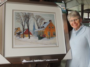 Auxiliary member Judith Bond with the next print at the Kincardine Hospital, which is entitled "Winter Morning Baie St. Paul"