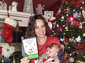 Two-time Olympic gold-medal winning goalie Shannon Szabados displays her children’s book, Every Bunny Loves to Play, alongside newborn daughter Shaylyn. Photo Supplied