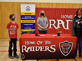 Devon resident Dianne Hennig presented her rescuers Bell (right) and Titus (left) Jeffery with a "Hennig Hero" medal on Dec. 4 at the Riverview Middle School.
(Emily Jansen)