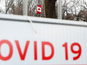 A sign leans against a fence in Tweed Memorial Park in May. Ontario has locked down two more southern Ontario regions and increased restrictions in five others because of increasing coronavirus cases and health system pressures.