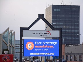 A digital billboard next to Revolution Place in advises residents that face coverings are mandatory Grande Prairie, Alta. on Thursday, Oct. 29, 2020. The bylaw was trigged after more than 100 actives cases were reported between the city and county.