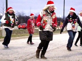 Members with the Sarnia Outta-Liners Line Dance Group perform as one of the entries in the drive-thru Santa Claus Parade at  Lambton College Dec. 5 in Sarnia. There was bumper-to-bumper traffic over three hours to see stationary displays in this year's modified parade event, organizers with the Sarnia Kinsmen Club said. Tyler Kula/Postedia Network