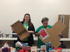 Santa for Seniors project co-organizers Emmalee Morton and Dava Robichaud are shown with a collection of items which will be distributed to seniors in Chatham-Kent later this month. (Handout/Postmedia Network)