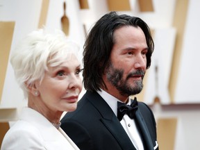 Keanu Reeves and Patricia Taylor pose on the red carpet during the Oscars arrivals at the 92nd Academy Awards in Hollywood, Los Angeles, California, U.S., February 9, 2020. REUTERS/Mike Blake