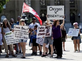 On the first day of Edmonton's mandatory indoor public space mask bylaw, approximately 50 anti-mask protestors marched from the Alberta Legislature to Edmonton City Hall, Saturday, Aug. 1, 2020. Photo by DAVID BLOOM / Postmedia