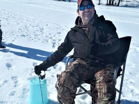 The author enjoying a relaxing day of winter fishing on the Ottawa River, during the 2018 Family Fishing Weekend.