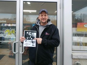 Mattawa deputy mayor Corey Lacelle holds a photo of hockey great Chick Webster in front of his Mr. Gas franchise in 2018. Lacelle has resigned from council for personal reasons after 10 years. File Photo