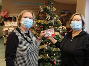 Beverley Horodyski, left and Leona Allen with Tourism Sarnia-Lambton hold gift certificates being sold by the agency to help boost local tourism businesses.