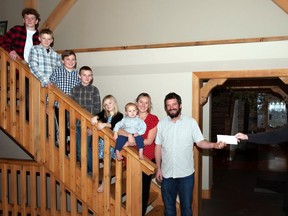 Handout/Cornwall Standard-Freeholder/Postmedia Network
A Dan Morency photo of Children's Treatment Centre honorary chair Sean Adams, right, accepting a donation from the Hagen family, owners of Blow Snow Removal Inc.

Handout Not For Resale