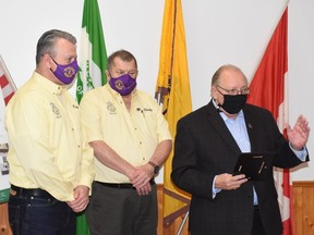 From left, Kevin Storozuk, president of the Lions Club of Petrolia, and past-president Charles Conrad listen as Sarnia-Lambton MPP Bob Bailey speaks during a recent celebration of renovations to the service club's hall.