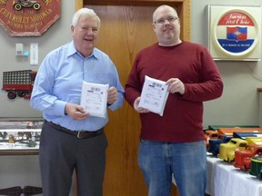 Rotarian Ken McGee (left) and his employee and packaging expert Josh Middelkamp, at Ken’s shop. They sent two of the Rotary fundraiser puzzles to the two Canadian Michaels imprisoned in China. Rotary supplied the puzzles and Ken donated the postings. Submitted