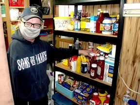 Ted Vanderlei, a volunteer at the Campbell AME Church soup kitchen, gets some supplies as the take-out meal was being prepared at the Chatham church on Dec. 16. Ellwood Shreve/Postmedia Network