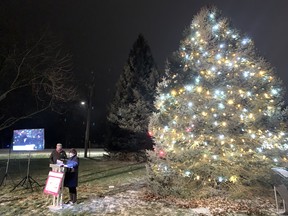 Chatham-Kent Health Alliance Foundation board members Gaye Thompson and Greg Hetherington stand by the Christmas Wish Tree after it was lit outside the Wallaceburg hospital on Dec. 16. Jake Romphf photo