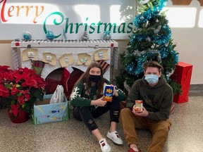 Heidi Acres and Josh Hoar, part of the Leadership Class at West Elgin Secondary School, show some of the items that were collected as part of the annual food and toy drive. Lori Smith photo