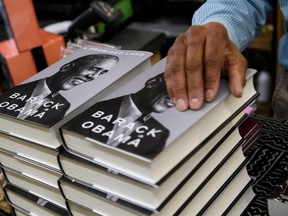 James Fugate, co-owner of Eso Won Books rests his hand on a stack of President Obama's book "A Promised Land" displayed for sale at Eso Won Books in the Leimert Park neighborhood of Los Angeles, California, November 24, 2020.