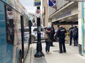 Kingston Police respond to a stabbing on a Kingston Transit bus downtown on Wednesday.