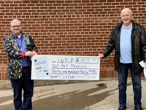 Roger Martin, left, PRHF executive director, presents the prize cheque to Art Horricks who won the weekly pot amount, $3,133, for week 21 of the PRHF's Catch the Ace progressive jackpot raffle. Submitted photo